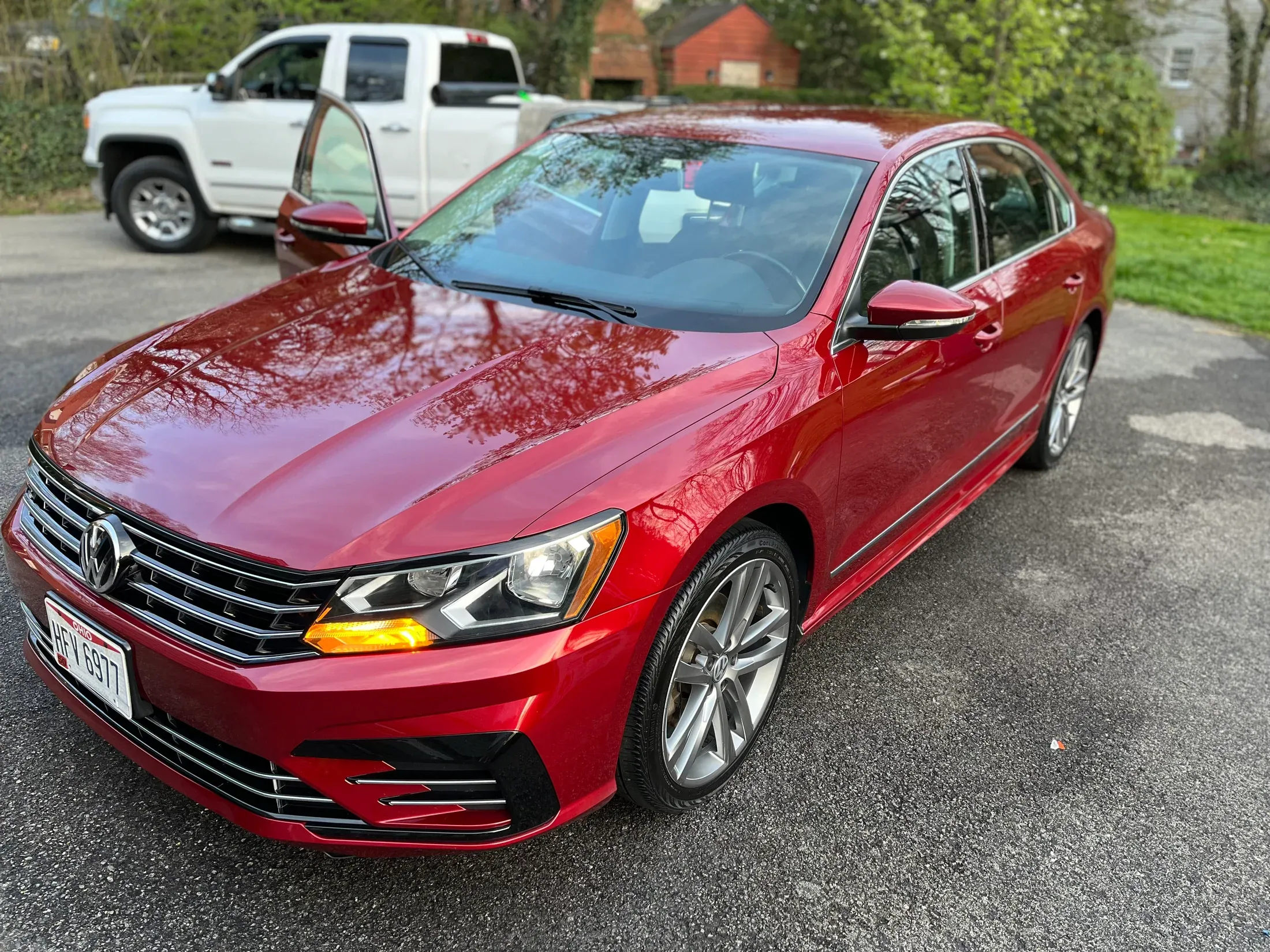 Glossy red Volkswagen sedan after detailing, viewed from the front.